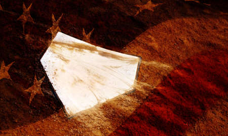 Home plate on baseball field with American Flag overの写真素材