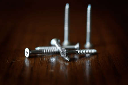 Screws pile of on wood tabletop workbench work bench for fixingの写真素材