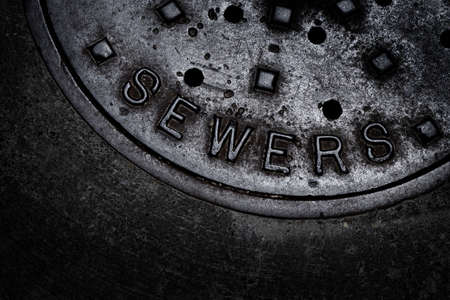 Sewer manhole cover maintenance iron steel access to utilityの写真素材