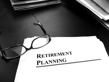 Retirement planning documents on desk with glasses for plan to retireの写真素材