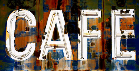 Old vintage gas cafe sign blue sky worn Americana on road roadsideの写真素材
