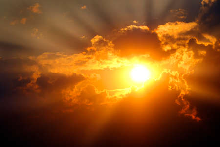 Sunlight sun rays shining through clouds in sky symbolizing hope and redemptionの写真素材