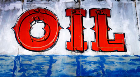 Old vintage worn Oil sign on highway road at old gas stationの写真素材