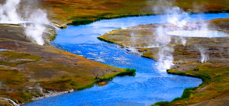 River flowing in wilderness with steam rising in Yellowstoneの写真素材