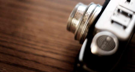 Detail of old worn vintage film camera closeup on wooden surfaceの写真素材