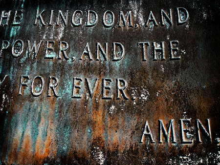 Closeup of bronze sculpture of the Lord's Prayer with focus on the word Amen