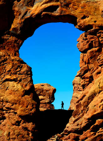 Silhouette of hiker in Turret Arch canyon rock formations Arches National Parkの写真素材