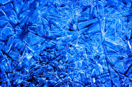Frozen ice patterns in winter cold freezing water crystals shapesの写真素材
