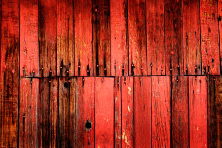 Old Red Barn Wooden Wall Background textured with several nailsの写真素材