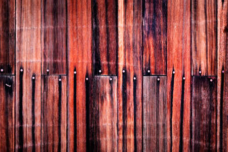 Old Red Barn Wooden Wall Background textured with several nailsの写真素材