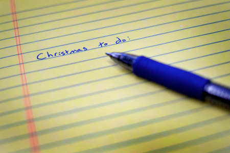 Written Christmas to do list on notebook paper and penの写真素材