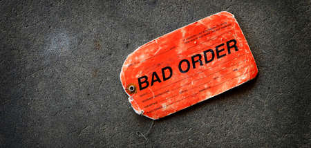 Red tag marker ticket or label with string for bad order on ground paperの写真素材
