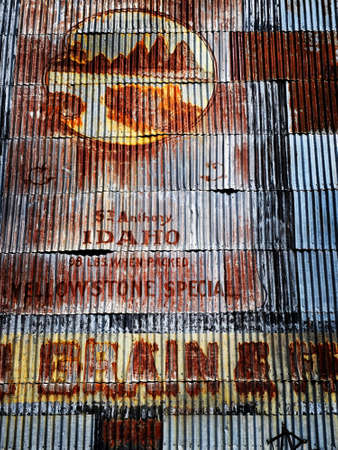 Old signs on wall of steel building of grain siloの写真素材