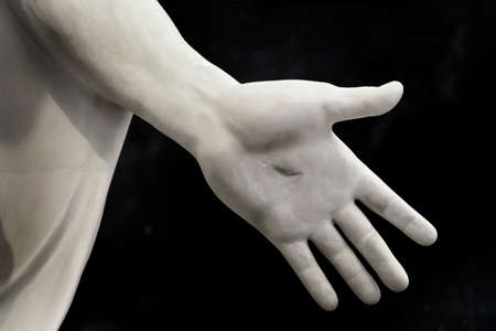 Detail of sculpted art of hand of Jesus with wound nail mark from crucifixionの写真素材