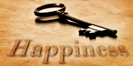 Key to Happiness on an old worn wooden desk topの写真素材
