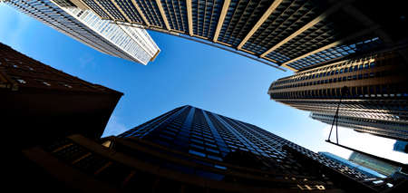 Highrise skyscraper buildings in a big city with blue sky urban setting metropolisの写真素材