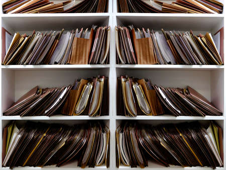 Stacks of Business files in boxes folders on shelf shelves papersの写真素材