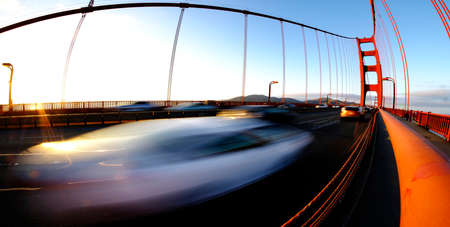 Golden Gate Bridge in San Francisco at evening with sunlight and traffic drivingの写真素材