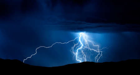 Powerful lightning extreme power dark stomy night over cityの写真素材