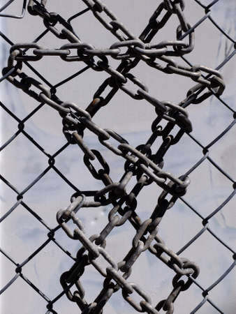 Chain wrapped around and through chainlink fence for security