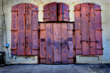Old building built with iron metal shutters for fire protectionの写真素材