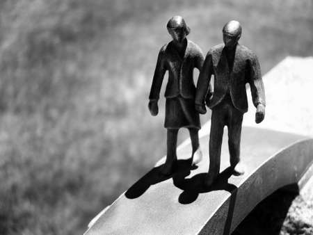 Business man and woman small figures walking together representing success