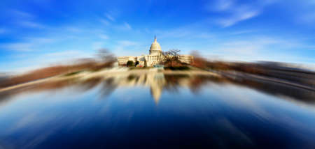 United State Capitol Building for congress with american flag flowing in breeze and columns in backgroundの写真素材