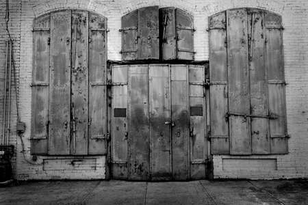 Old building built with iron metal shutters for fire protectionの写真素材