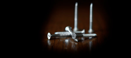 Screws pile of on wood tabletop workbench work bench for fixingの写真素材