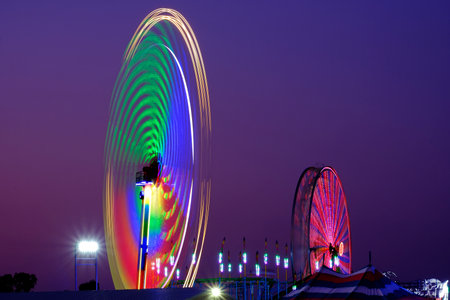 Fun rides at a fair or carnival at nightの写真素材