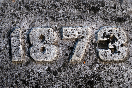 Roughly textured carved numbers in stone 1873の写真素材