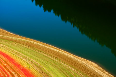 Colorful nature and natural textures and colors on shoreline of lake red green and yellowの写真素材
