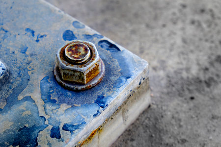 Strong large bolt and nut securing metal to ground strengthの写真素材
