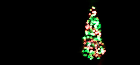 Christmas Tree in house with warm glowing lights blurred out of focus backgroundの写真素材