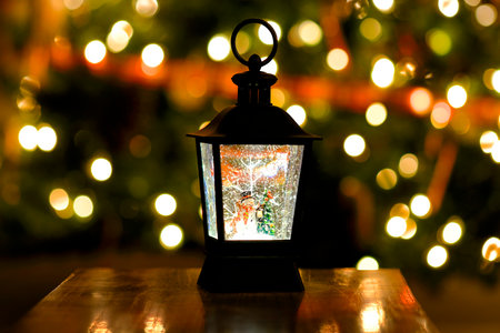 Wintertime Christmas decorations with festive globe snowing on snowman with lightsの写真素材