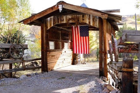 Old covered wooden bridge with American Flag Americanaの写真素材