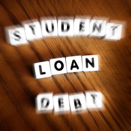 Student loan debt words letters on block dice representing massive payments and financial stress zoom motionの写真素材