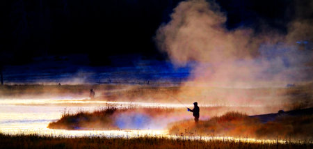 Silhouette of Fishing Flyfishing rod reel in river with golden sunlightの写真素材