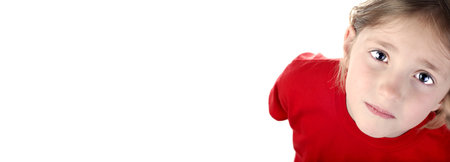 Portrait of young girl with red shirt on white background and sad expressionの写真素材