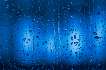 Detail of water drops from rain running down window rainy dayの写真素材