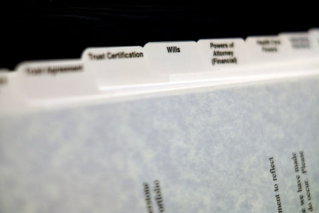 Estate planning documents organized with tabs for Will Power of Attorney and Trustの写真素材