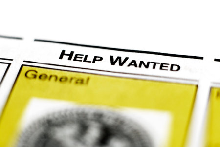 Closeup of newspaper clipping for help wanted advertisement for employmenbt and labor jobsの写真素材