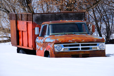 Old work truck worktruck buried in deep snow after winter storm snowstormの写真素材