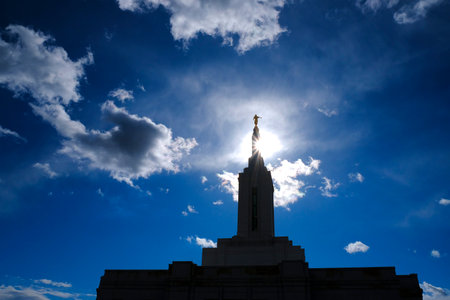 Angel Moroni on top of Mormon LDS Church of Jesus Christ Temple with sky and cloudsの写真素材