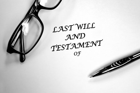 Last Will and Testament document with glasses and pen on desk for signingの写真素材