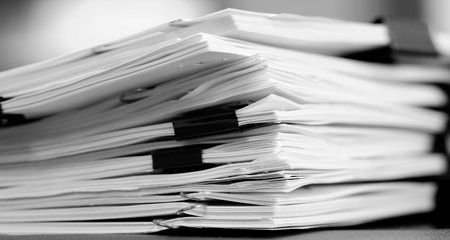 Pile of papers with binder clips paperclips business for organizing on Desk Work to Be doneの写真素材