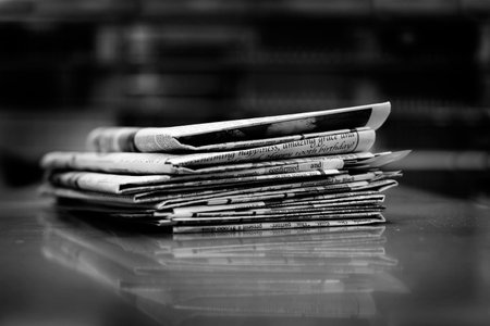 Stacks of old newspapers printed on paper with news and headlinesの写真素材