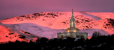 Pocatello LDS Mormon Temple in winter at sunset with golden orange light on snowの写真素材