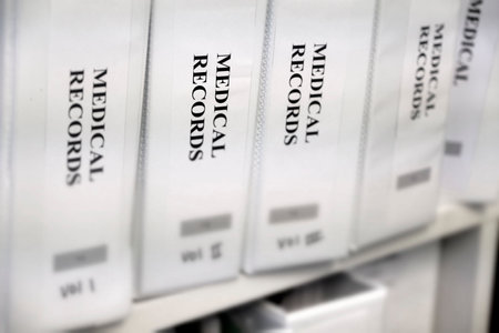 Medical records organized in binders on shelf for record keepingの写真素材