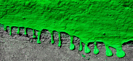 Closeup of dripping green paint texture on concreteの写真素材